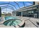 Beautiful backyard with pool, spa, screened-in lanai, and outdoor seating areas, great for entertaining at 303 W Grace St, Punta Gorda, FL 33950