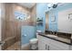 Bathroom featuring a walk-in shower with tile surround, granite countertops, and plank flooring at 303 W Grace St, Punta Gorda, FL 33950