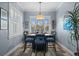Formal dining room featuring wood floors, a decorative chandelier, and natural lighting at 303 W Grace St, Punta Gorda, FL 33950