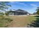 The exterior of a beautiful grey home with a screened in back porch and spacious lawn at 303 W Grace St, Punta Gorda, FL 33950