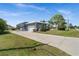 A long driveway leading up to a single-Gathering home with a two-car garage and screened-in back porch at 303 W Grace St, Punta Gorda, FL 33950