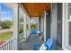 Inviting front porch with swing, chair, wood ceiling and painted gray floor at 303 W Grace St, Punta Gorda, FL 33950