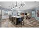 Open kitchen with a spacious island, wine cooler, modern lighting, and views into the adjacent living room at 303 W Grace St, Punta Gorda, FL 33950