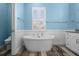Freestanding soaking tub in the main bathroom with separate WC and storage at 303 W Grace St, Punta Gorda, FL 33950