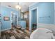 Main bathroom featuring a soaking tub, walk-in shower, and dual sinks at 303 W Grace St, Punta Gorda, FL 33950