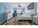 Bright main bedroom featuring a king-sized bed, multiple dressers, and plank flooring at 303 W Grace St, Punta Gorda, FL 33950