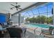 Outdoor patio with grill, ceiling fans, pool, spa, and plenty of seating for guests at 303 W Grace St, Punta Gorda, FL 33950