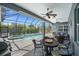 Covered outdoor patio with a ceiling fan, a built in grill, pool, spa, and plenty of room to entertain at 303 W Grace St, Punta Gorda, FL 33950