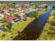 Waterfront homes with pools and lanais line a peaceful canal in a sunny Florida community at 32 Long Meadow Ln, Rotonda West, FL 33947
