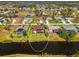 Expansive aerial view of the property backing onto a canal, showcasing the pool and surrounding greenery at 32 Long Meadow Ln, Rotonda West, FL 33947