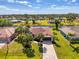 Aerial view of a beautiful home and canal front property surrounded by lush landscaping at 32 Long Meadow Ln, Rotonda West, FL 33947
