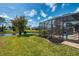 Expansive backyard with a screened lanai, pool, and picturesque lake view at 32 Long Meadow Ln, Rotonda West, FL 33947