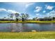 Peaceful waterfront backyard with lush greenery and serene canal view at 32 Long Meadow Ln, Rotonda West, FL 33947
