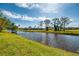 Scenic backyard view overlooking a tranquil canal under a blue sky at 32 Long Meadow Ln, Rotonda West, FL 33947
