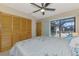 Bright bedroom featuring closet and sliding glass door to screened lanai at 32 Long Meadow Ln, Rotonda West, FL 33947