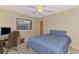 Comfortable bedroom with a ceiling fan, desk, and a window bringing in natural light at 32 Long Meadow Ln, Rotonda West, FL 33947