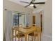 Cozy dining area featuring a ceiling fan, sliding glass door, and views of the yard at 32 Long Meadow Ln, Rotonda West, FL 33947