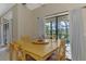 Bright dining area with sliding glass doors opening to backyard, set with four-chair dining table at 32 Long Meadow Ln, Rotonda West, FL 33947