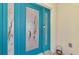 A vibrant blue front door with decorative glass and secure digital lock system at 32 Long Meadow Ln, Rotonda West, FL 33947