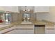 Renovated kitchen features granite countertops, stainless appliances, and view of outside dining at 32 Long Meadow Ln, Rotonda West, FL 33947
