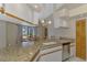 Updated kitchen with granite counters and stainless steel appliances, and adjacent eating area at 32 Long Meadow Ln, Rotonda West, FL 33947