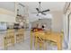 Bright kitchen features white cabinets, granite counters, stainless appliances, and an adjacent dining area at 32 Long Meadow Ln, Rotonda West, FL 33947