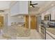 Bright kitchen features granite countertops, stainless steel appliances, and tile flooring at 32 Long Meadow Ln, Rotonda West, FL 33947