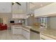 Modern kitchen boasts granite counters, stainless appliances, and access to living and dining areas at 32 Long Meadow Ln, Rotonda West, FL 33947