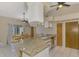 Open concept kitchen features granite counters, stainless appliances, and an adjacent dining area at 32 Long Meadow Ln, Rotonda West, FL 33947