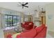 Open-concept living room with pool view through sliding glass doors and modern decor at 32 Long Meadow Ln, Rotonda West, FL 33947