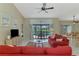 Living room with view of outdoor pool through sliding glass doors and colorful rug at 32 Long Meadow Ln, Rotonda West, FL 33947