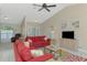 Open living room with tile floors, sliding glass doors, and comfortable red sofas at 32 Long Meadow Ln, Rotonda West, FL 33947