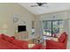 Bright living room with a sliding glass door leading to outdoor pool and lanai at 32 Long Meadow Ln, Rotonda West, FL 33947
