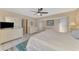 Large bedroom with tile floors, an entertainment center and a sun-filled window for natural light at 32 Long Meadow Ln, Rotonda West, FL 33947