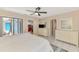 A bright bedroom with a ceiling fan and sliding glass doors leading to a screened in porch at 32 Long Meadow Ln, Rotonda West, FL 33947
