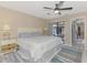 Spacious bedroom with a ceiling fan, an area rug, and a sliding glass door to the screened in porch at 32 Long Meadow Ln, Rotonda West, FL 33947
