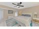 Spacious main bedroom features ceiling fan, white furnishings, and an area rug at 32 Long Meadow Ln, Rotonda West, FL 33947