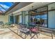Inviting screened-in patio featuring an outdoor dining area and stylish decor at 32 Long Meadow Ln, Rotonda West, FL 33947