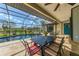Inviting screened patio with outdoor dining set next to private pool at 32 Long Meadow Ln, Rotonda West, FL 33947
