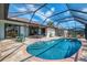 Sparkling pool with a screened enclosure and view of the home's exterior at 32 Long Meadow Ln, Rotonda West, FL 33947