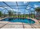 Inviting pool with a screened enclosure overlooking a serene backyard lake at 32 Long Meadow Ln, Rotonda West, FL 33947