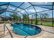 Inviting screened-in pool area with a tranquil water view, perfect for relaxation and outdoor enjoyment at 32 Long Meadow Ln, Rotonda West, FL 33947