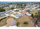 Aerial view of a well-maintained neighborhood with a lake in the background at 3249 Sunrise Trl, Port Charlotte, FL 33952