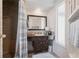 Bathroom featuring a brown tiled shower and vanity with marble countertops at 3249 Sunrise Trl, Port Charlotte, FL 33952
