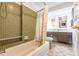 Bathroom featuring green tiled shower and vanity with marble countertops at 3249 Sunrise Trl, Port Charlotte, FL 33952