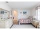 Cozy bedroom with light wood floors, white walls and coastal decor at 3249 Sunrise Trl, Port Charlotte, FL 33952