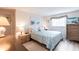 Bright bedroom with plank flooring and a comfortable bed, perfect for rest and relaxation at 3249 Sunrise Trl, Port Charlotte, FL 33952