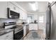 Modern kitchen with stainless steel appliances, granite countertops, and ample cabinet space at 3249 Sunrise Trl, Port Charlotte, FL 33952
