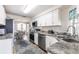 Efficient kitchen featuring stainless appliances, updated cabinets, and easy access to the adjacent dining area at 3249 Sunrise Trl, Port Charlotte, FL 33952