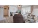 Inviting living room with plank flooring, cozy seating, and a view of the screened-in porch at 3249 Sunrise Trl, Port Charlotte, FL 33952